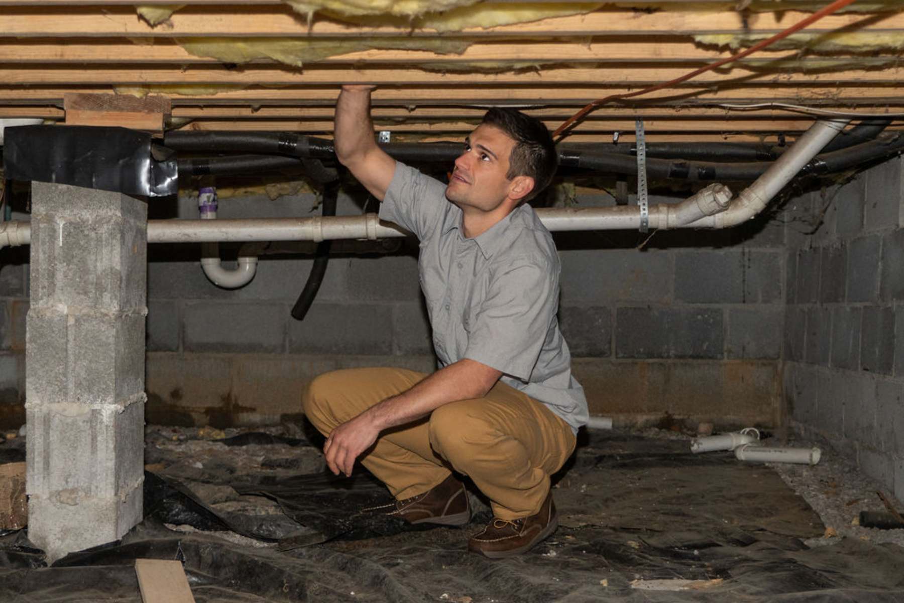 Chase Grimm inspecting a crawl space